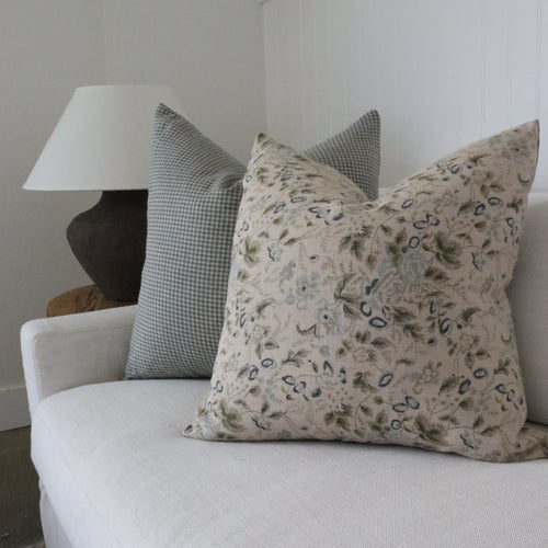 Decorative pillows on a white sofa with a neutral color scheme.