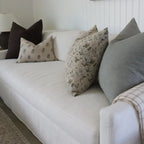 White sofa with patterned cushions in a living room setting