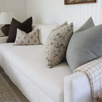 White sofa with patterned cushions in a living room setting